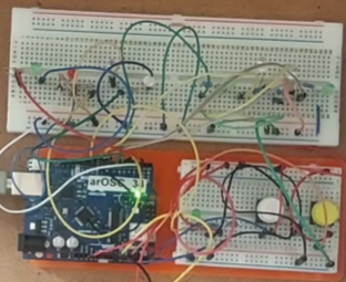 Image of an arduino with buttons and a slider for inputs and LED's for output